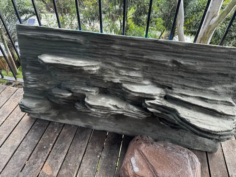 The blue disappears — four-foot layered rock backdrop being made by hand