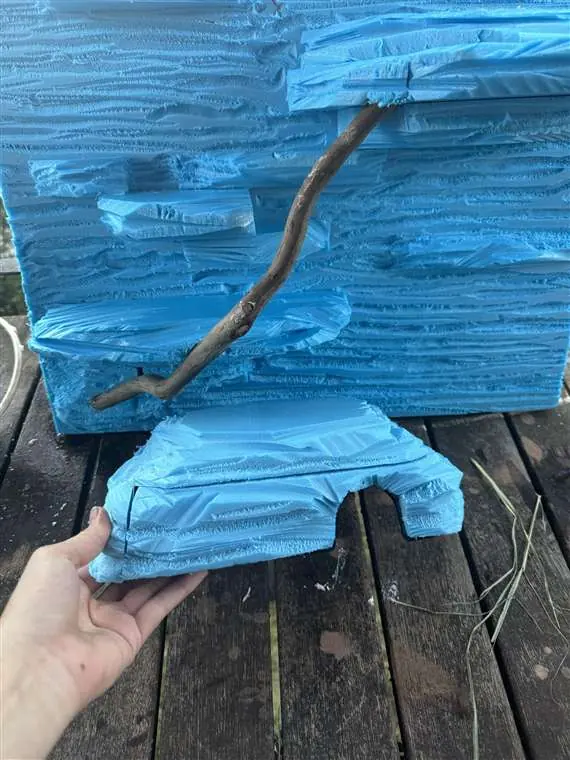 Blue foam backdrop and matching hide during the hand-shaping stage